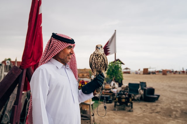 A man holding a Falcon in his hand