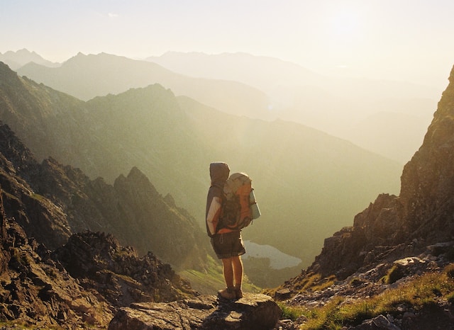 A solo backpack traveller hiking on a mountain