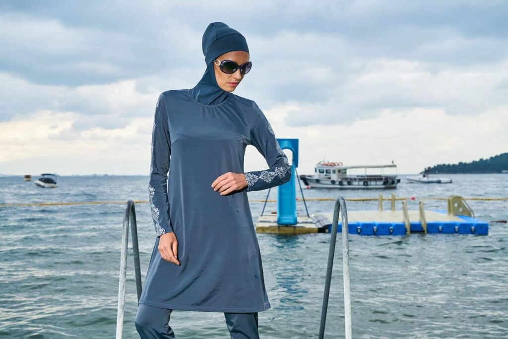 A woman dressed in burkini near the beach