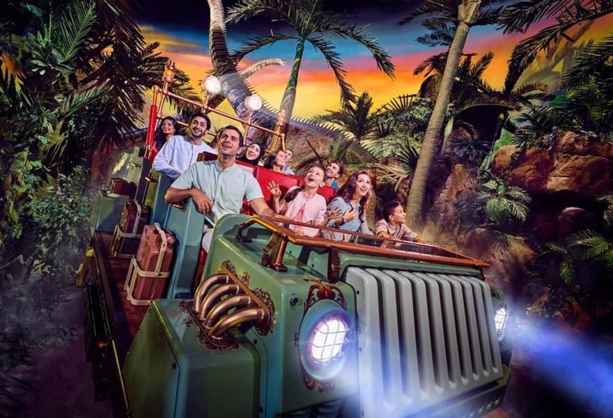 Visitors riding in a jeep inside the IMG world 's lost valley zone