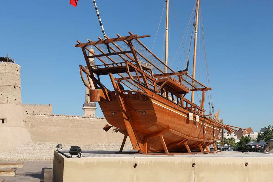 A traditional arab boat is displayed outside the museum