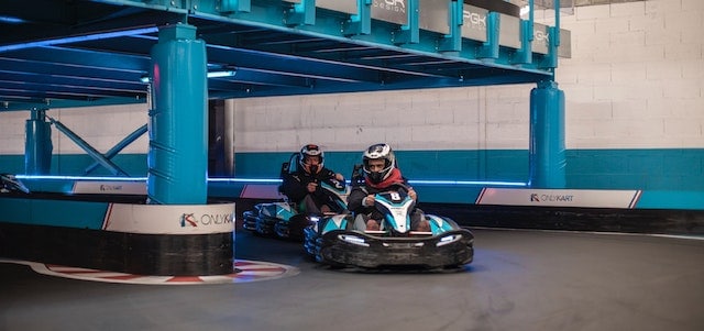 Two people riding go kart