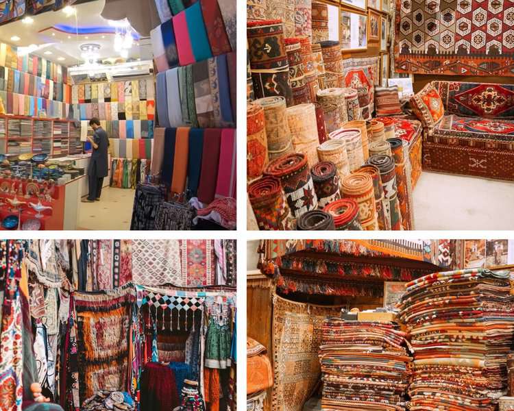shawls, carpets, bedsheets are displayed in traditional shops in a Dubai Souq