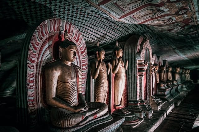 several buddha statues inside the Dambulla cave temple