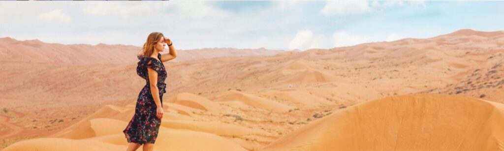 A woman standing in a desert area