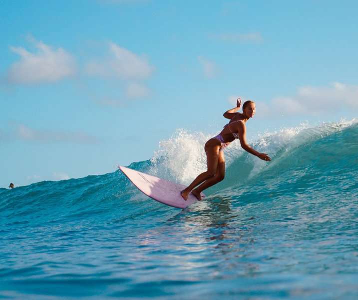 a woman surfing on sunny afternoon