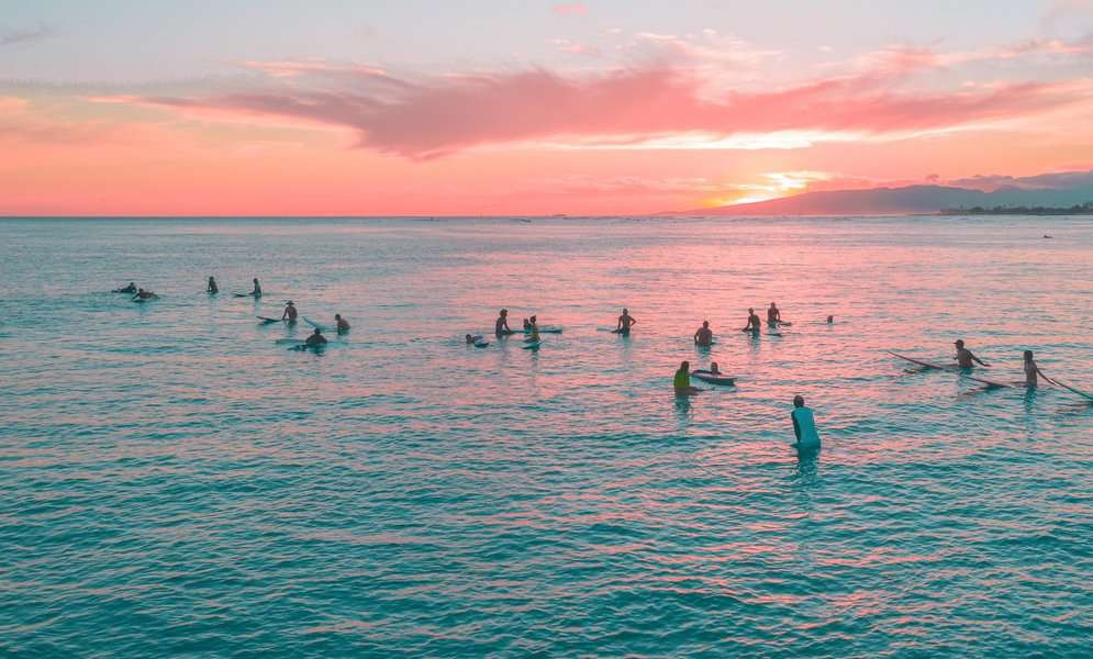 surfers waiting for the waves to surf early in the morning