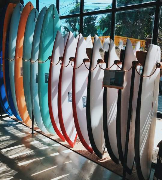 Different type of surfing boards put on display in a shop