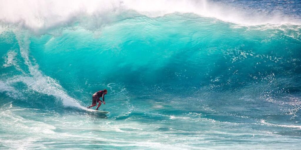 surfer surfing under the big wave