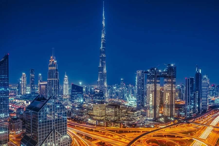 A colorful night view of Dubai City including the Burj Khalifa