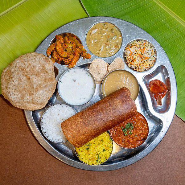 Vegetarian food plate with variety curries displayed in a plate