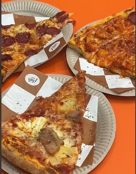 Three variety of pizza slices displayed at Phils Pizza in KL