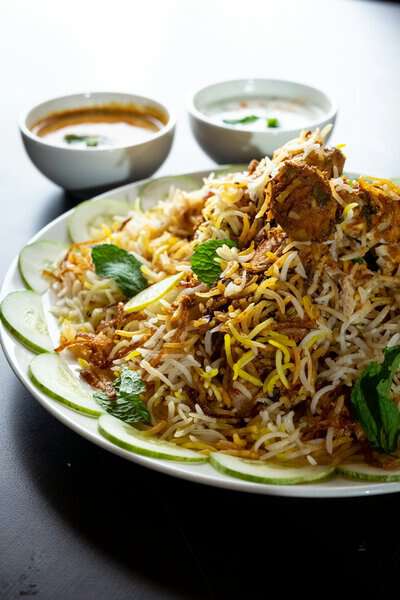 A plate of Buriyani with side dishes