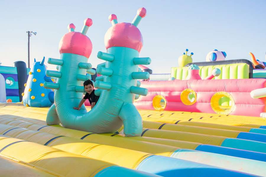 A small boy playing in the bouncing castle