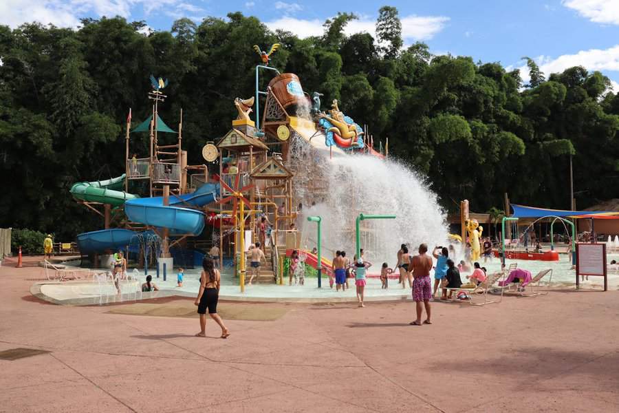 a small water park with pool and castle with slides