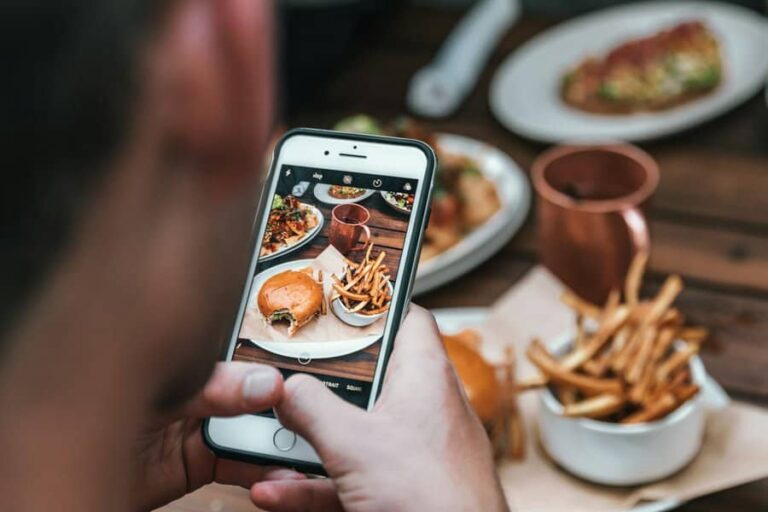 A man taking Instagram image of his food