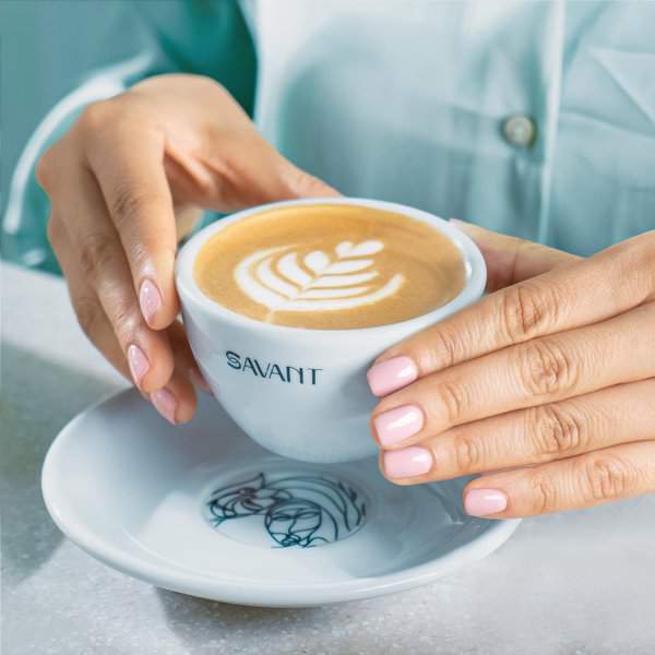 A man holding a savant cafe coffee